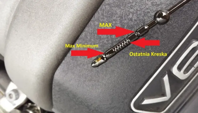 Jak odczytać poziom oleju na bagnecie: poziom oleju jest między "Max" a "Ostatnia Kreska", co oznacza prawidłowy stan.